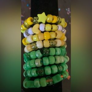 Bracelet set of eight, green and yellow themed.